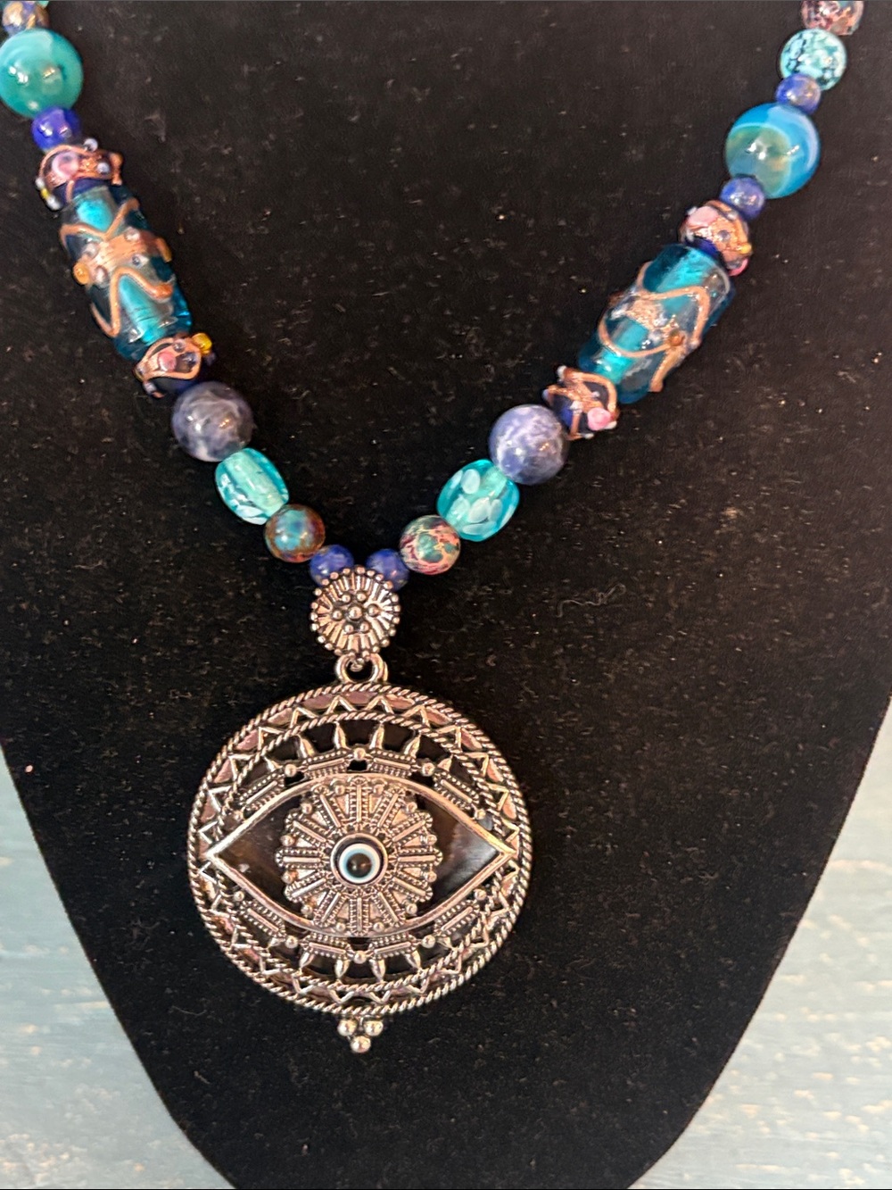 Vintage evil eye magnifying glass on vintage lamp, work bead necklace